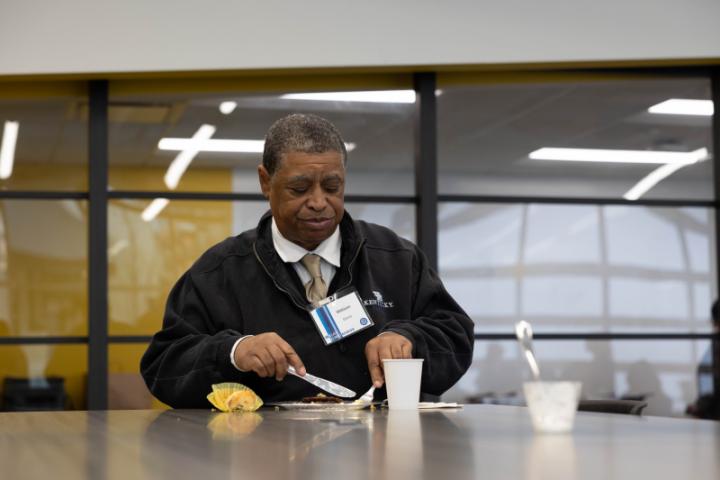 An attendee sits eating breakfast